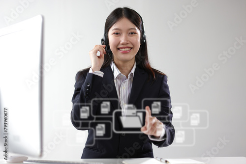 Telephone operator works with computer in office and talks with customers.