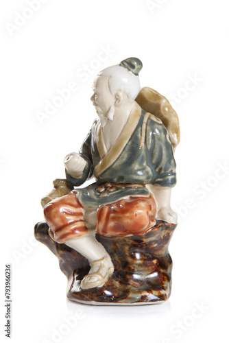 Chinese elder porcelain figurine isolated on white background.