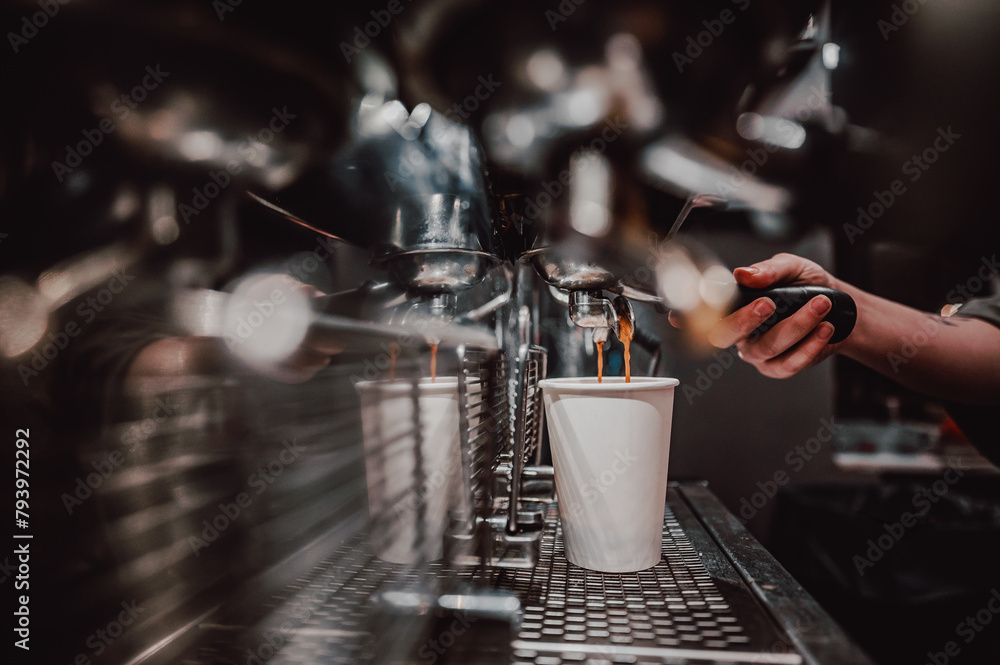 Skilled barista operating an espresso machine, filling a white cup with fresh coffee in a cozy café ambiance - obrazy, fototapety, plakaty 