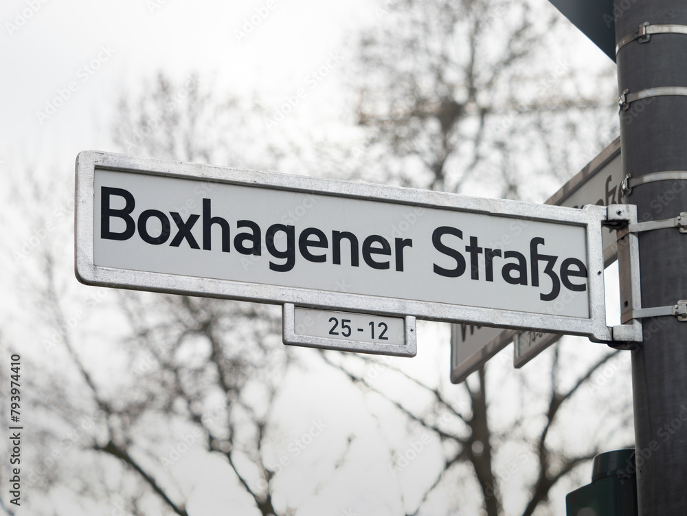 Boxhagener Straße street sign in Berlin. Road name guide at an intersection. The location is in the popular district Friedrichshain and a travel destination for many young tourists. Boxhagener Straße street sign in Berlin. Road name guide at an intersection. The location is in the popular district Friedrichshain and a travel destination for many young tourists.