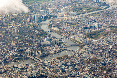 High aerial view of downtown city of London, with river Thames, the Shard, Tower bridge, HMS Belfast and may buildings, squares, offices. Taken from airplane photo