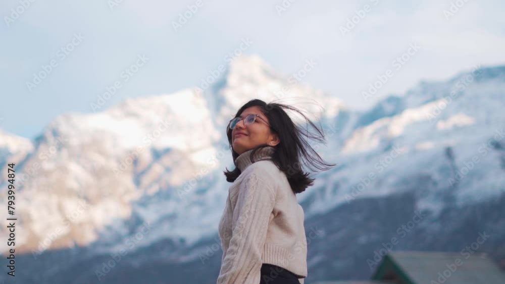 Portrait of happy Indian girl portrait. Girl standing against snow mountains in Lahaul, Himachal Pradesh, India. Tourist enjoying holiday trip in mountains. Solo traveler, backpacking concept. Portrait of happy Indian girl portrait. Girl standing against snow mountains in Lahaul, Himachal Pradesh, India. Tourist enjoying holiday trip in mountains. Solo traveler, backpacking concept.