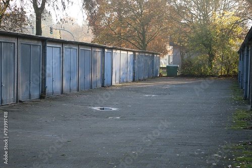 View of a path with many old garages next to each other with metal doors