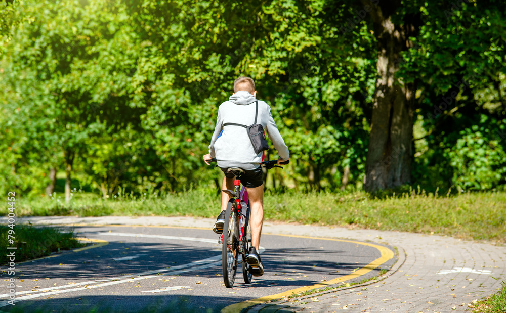 Fototapeta premium Cyclist ride on the bike path in the city Park 