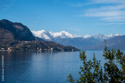 Driving car along shores of Lake Como in Northern Italy, spring sunny days, views of alpine mountains, water and villages