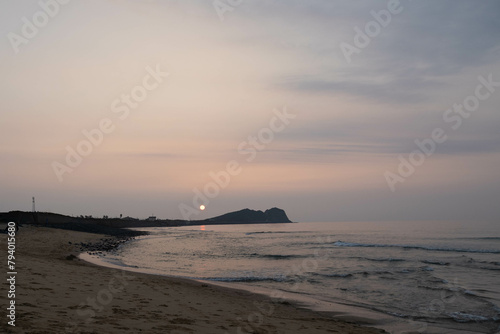 8月の夕日と海と砂浜 photo
