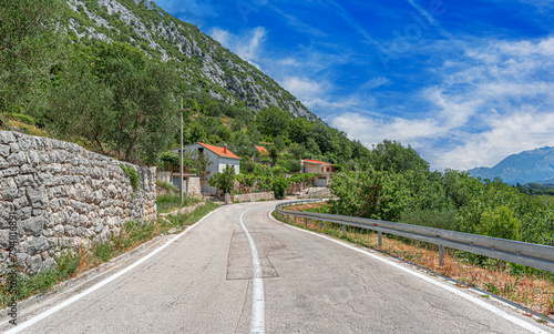 Rural road in the Adriatic region. Country road with rocky mountains in the background.