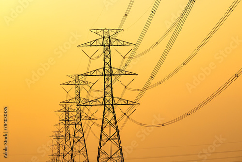 Silhouette of electricity transmission pylon. High voltage electric tower lines.