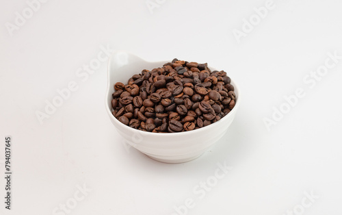 Coffee beans are poured into a ceramic bowl