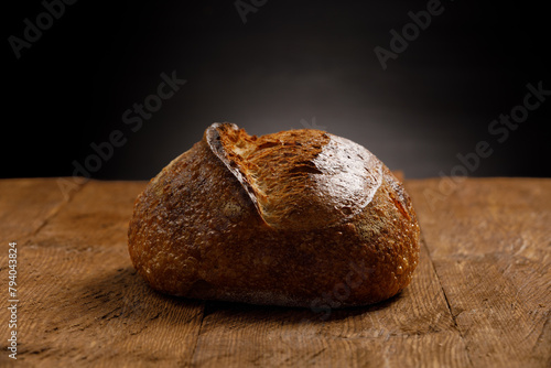 Rustic sourdough bread on rustic wooden background.