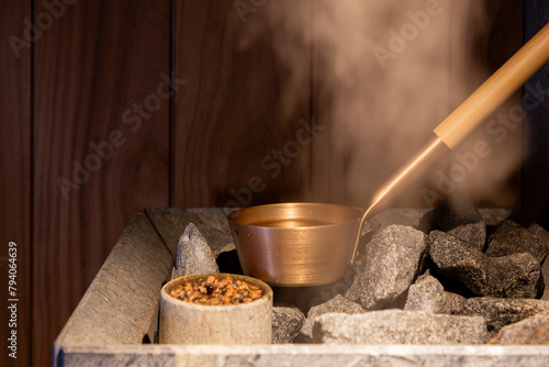 ladle for pouring water on hot stones in the sauna and steam  photo