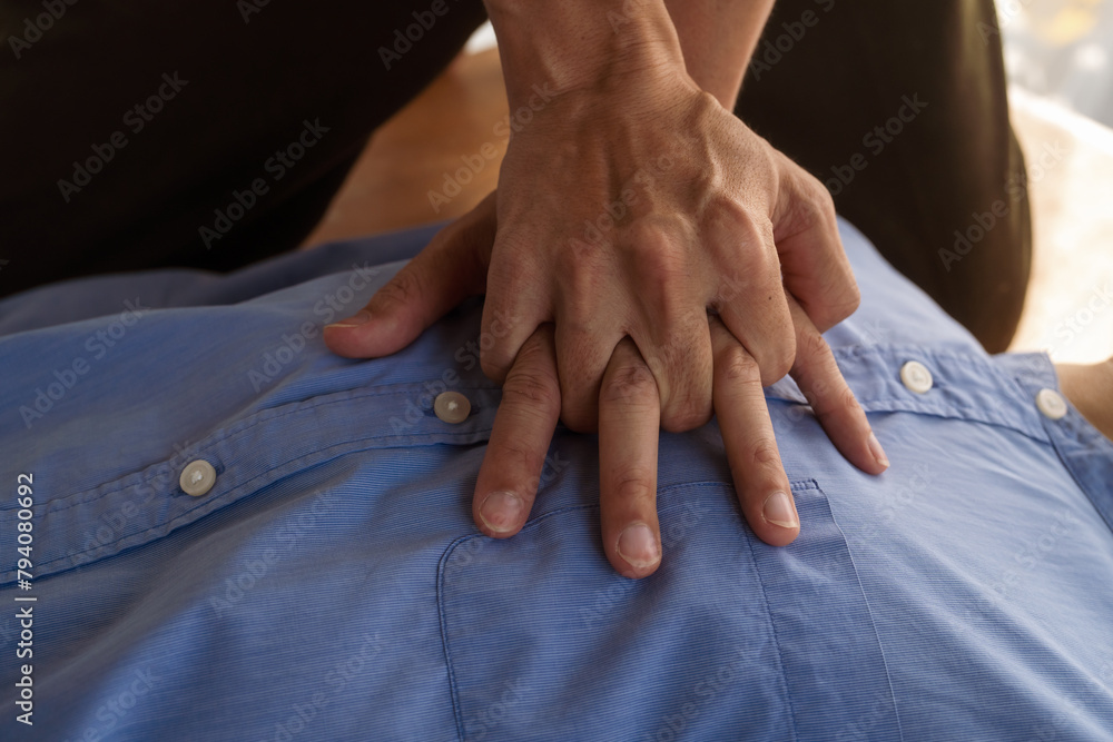 A focused view of a man demonstrating chest compressions on a CPR training class, illustrating hands-on learning in a classroom setting to master life-saving techniques for emergency response. A focused view of a man demonstrating chest compressions on a CPR training class, illustrating hands-on learning in a classroom setting to master life-saving techniques for emergency response.
