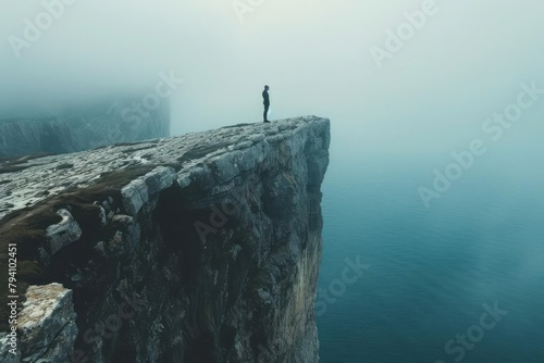 Visual of a person standing at the edge of a cliff, metaphor for mental health crisis