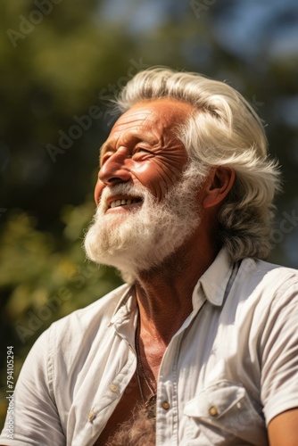 b'Portrait of an old man with white hair and beard smiling'