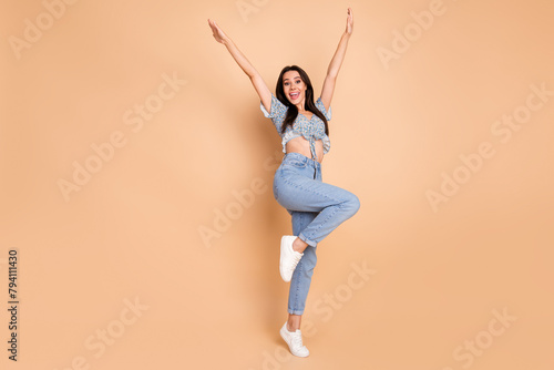Photo of stunning lovely positive woman dressed blue trendy outfit standing empty space isolated on beige background