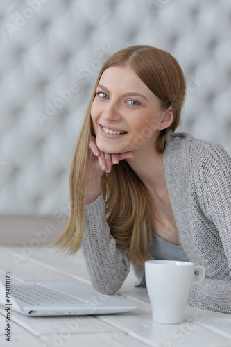 Portrait of a happy young girl with laptop computer