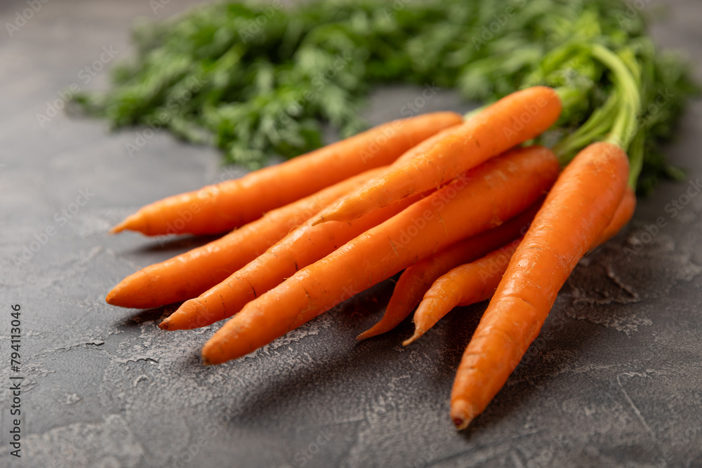 Carrots on a textured wooden background. Fresh and sweet organic carrots on a white background. Carrot slices. Vegan. Ingredients for salad. Place for text. Copy space. Flatley Carrots on a textured wooden background. Fresh and sweet organic carrots on a white background. Carrot slices. Vegan. Ingredients for salad. Place for text. Copy space. Flatley