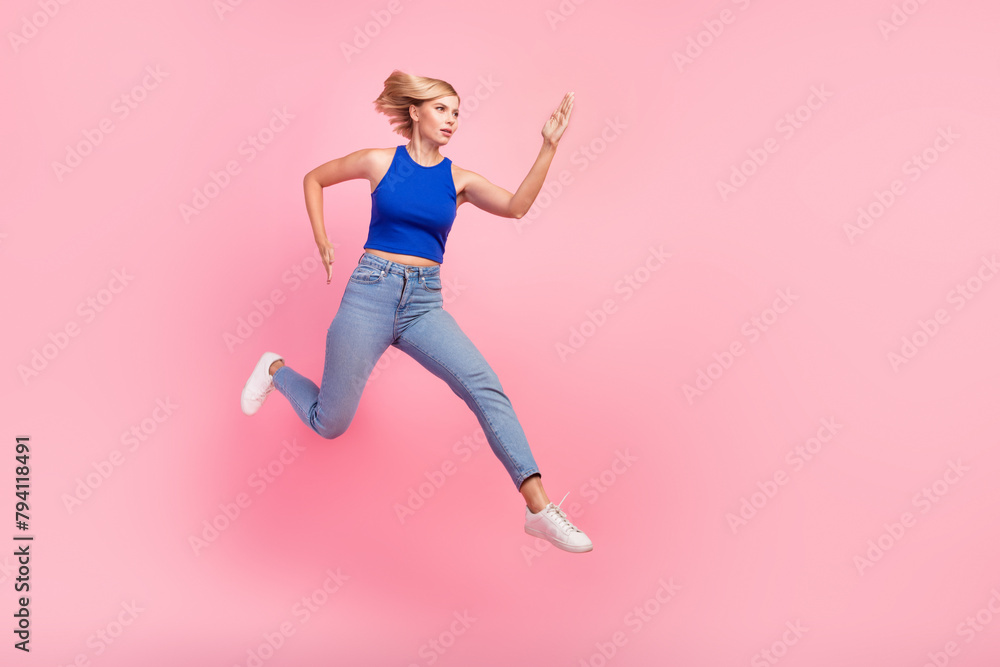 Full body portrait of nice girl jump rush empty space wear blue top isolated on pink color background Full body portrait of nice girl jump rush empty space wear blue top isolated on pink color background