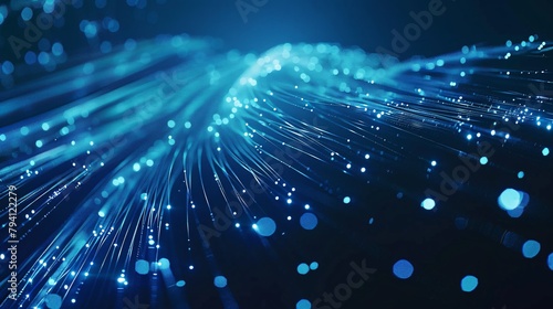 Close-up of blue fiber optic cables emitting bright, glowing light points. Abstract background. 