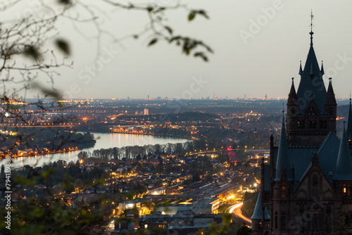 Drachenburg Castle in the Siebengebirge, Germany. On the horizon the Cologne Cathedral in the Sahara dust at the blue hour.