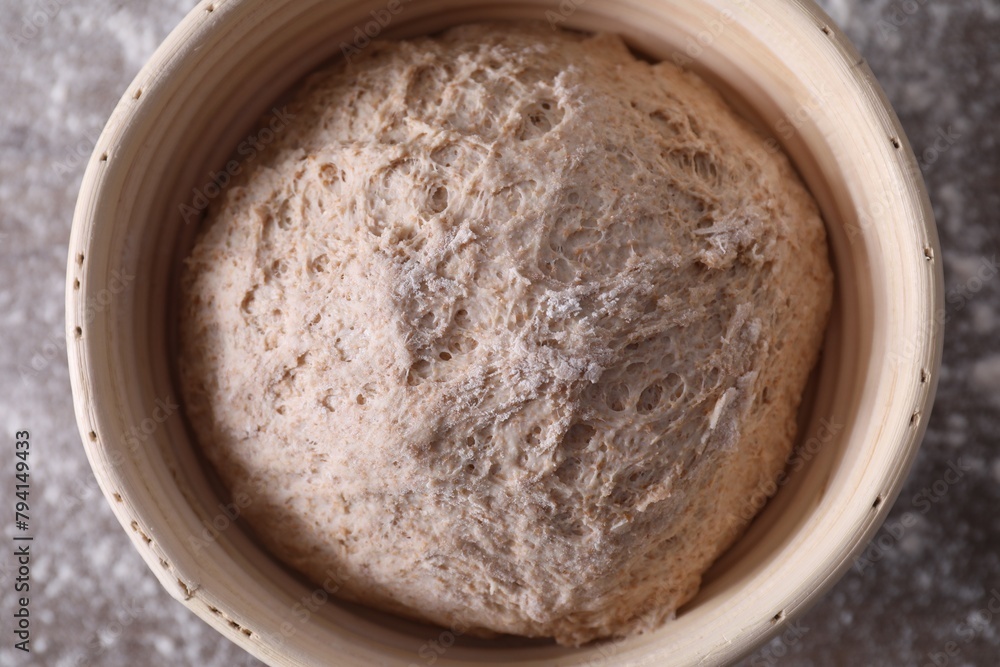 Fresh sourdough in proofing basket on table, top view Fresh sourdough in proofing basket on table, top view