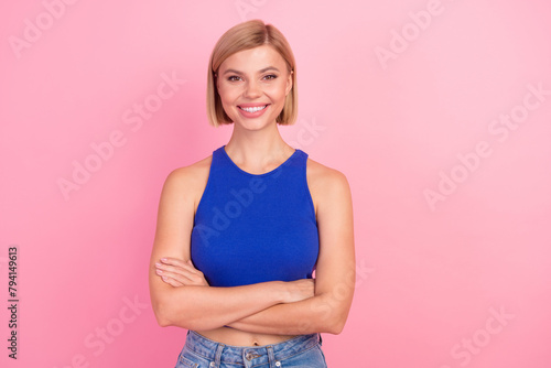 Portrait of nice young girl crossed arms wear blue top isolated on pink color background