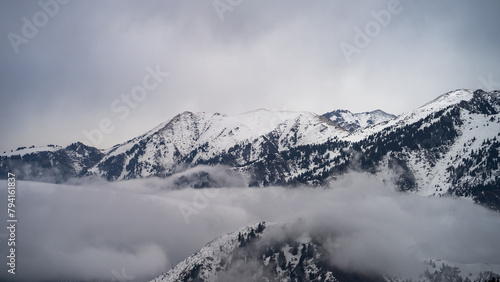 snowy mountain peaks in the clouds. cloud cover in the mountains