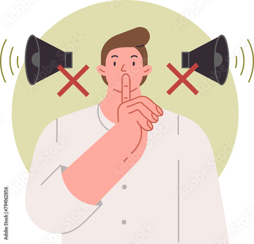 Man makes tss gesture urging to switch phone to airplane mode and speak in whisper, standing near crossed out megaphones. Guy recommends keeping quiet so as not to disturb people around him. photo