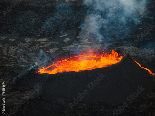 Fantastic directly above close-up shot of boiling glowing lava inside a volcano crater  aerial view. Amazing natural phenomena concept.