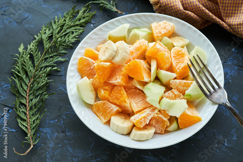 Fresh Citrus and Banana Fruit Salad Served on a White Plate With a Rustic Background