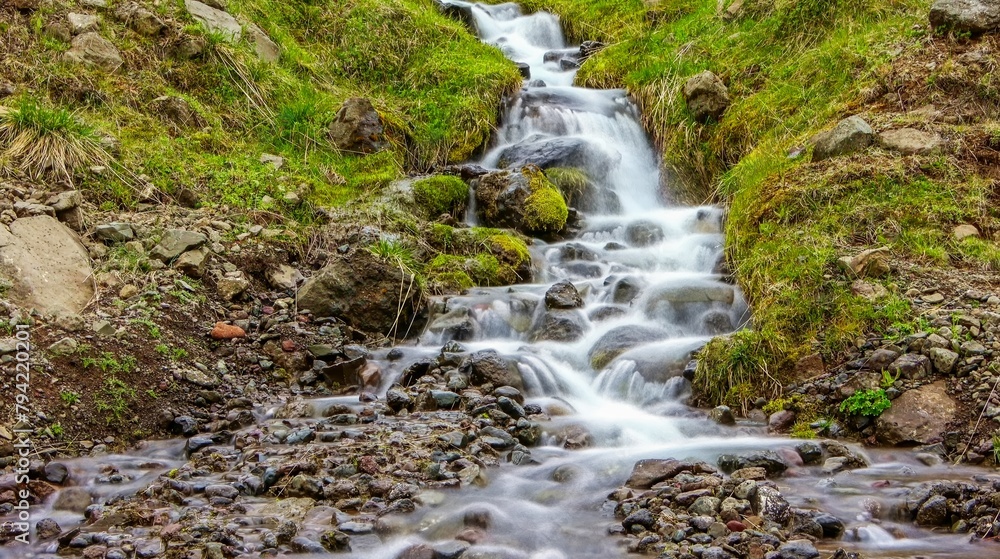 Naklejka premium Long exposure of a waterfall in a rocky landscape in Iceland
