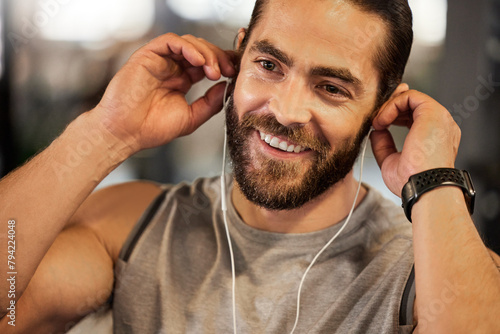 Gym, fitness or happy man with earphones for music, streaming or listening to podcast for workout inspiration. Health, wellness or athlete with audio, sound and radio for sports, exercise or training