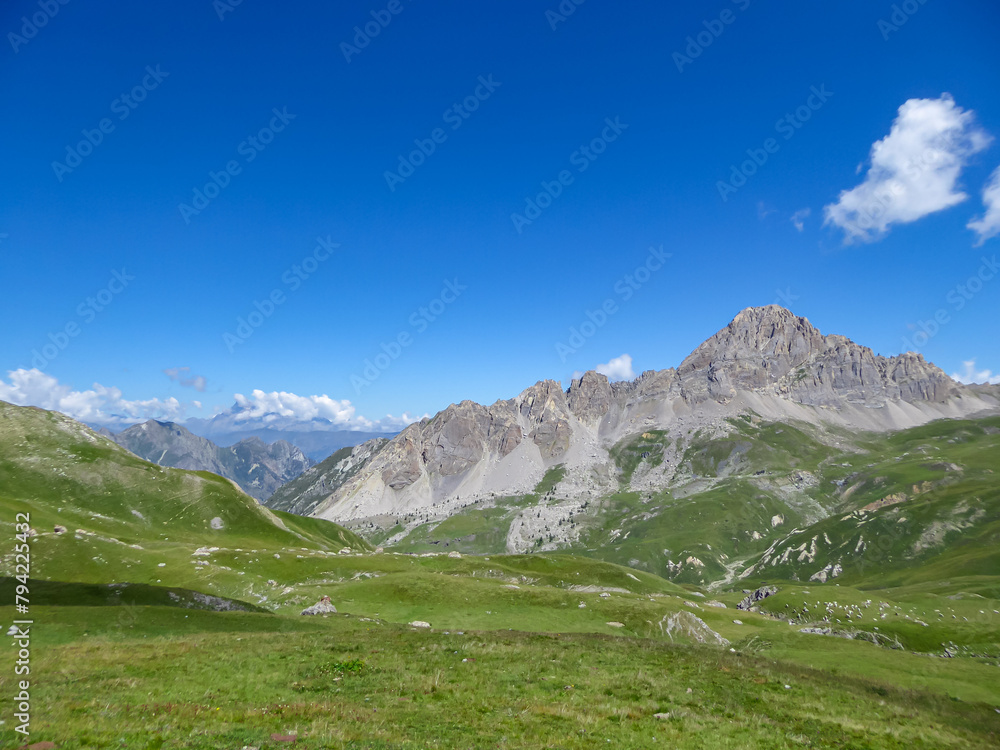 Scenic mtb trail with view of Rocca La Meja near rifugio della Gardetta on the Italy French border in Maira valley in the Cottian Alps, Piedmont, Italy, Europe. Hiking on sunny summer day in mountains