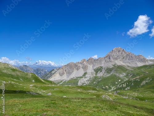 Scenic mtb trail with view of Rocca La Meja near rifugio della Gardetta on the Italy French border in Maira valley in the Cottian Alps, Piedmont, Italy, Europe. Hiking on sunny summer day in mountains © Chris
