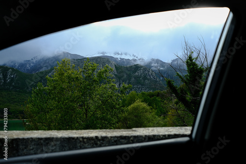 Piece of panorama with mountains seen through the car window