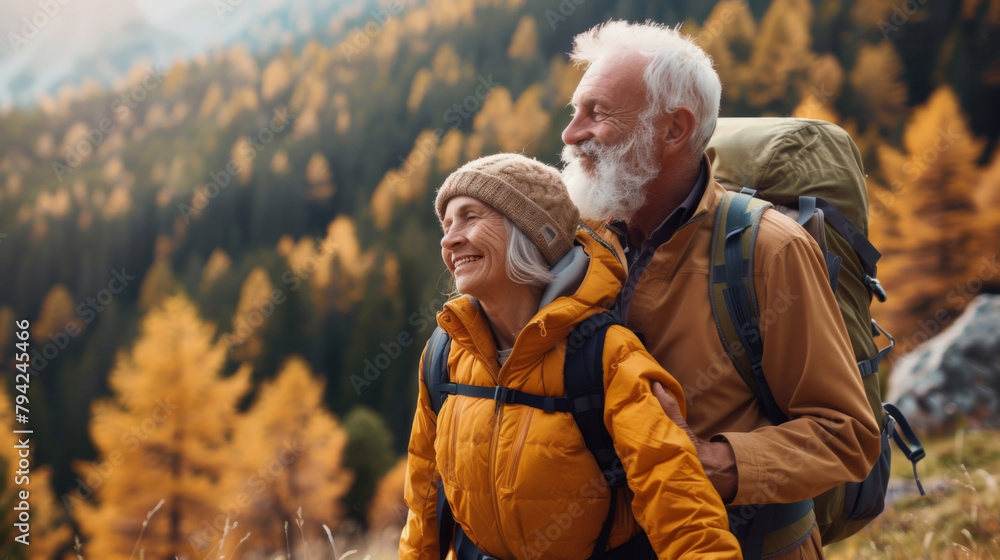An elderly couple in colorful hiking clothes enjoy their climb up the mountain. Adult man and woman are hiking. The concept of a happy old age, active lifestyle. An elderly couple in colorful hiking clothes enjoy their climb up the mountain. Adult man and woman are hiking. The concept of a happy old age, active lifestyle.