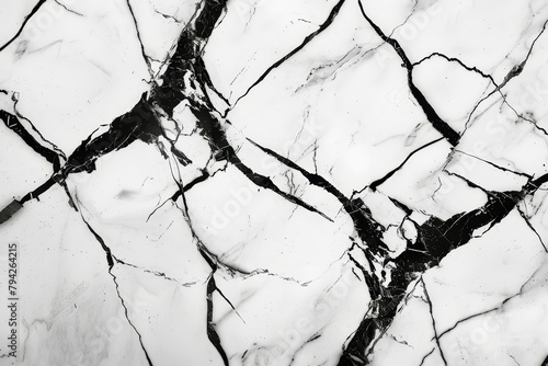   A monochrome image of a marbled surface displaying intricate crisscross cracks, with a notable concentration in the photo's center photo