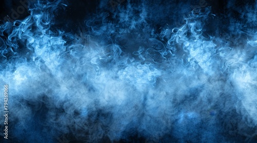   Black backdrop with copious blue smoke rising from its upper portion photo