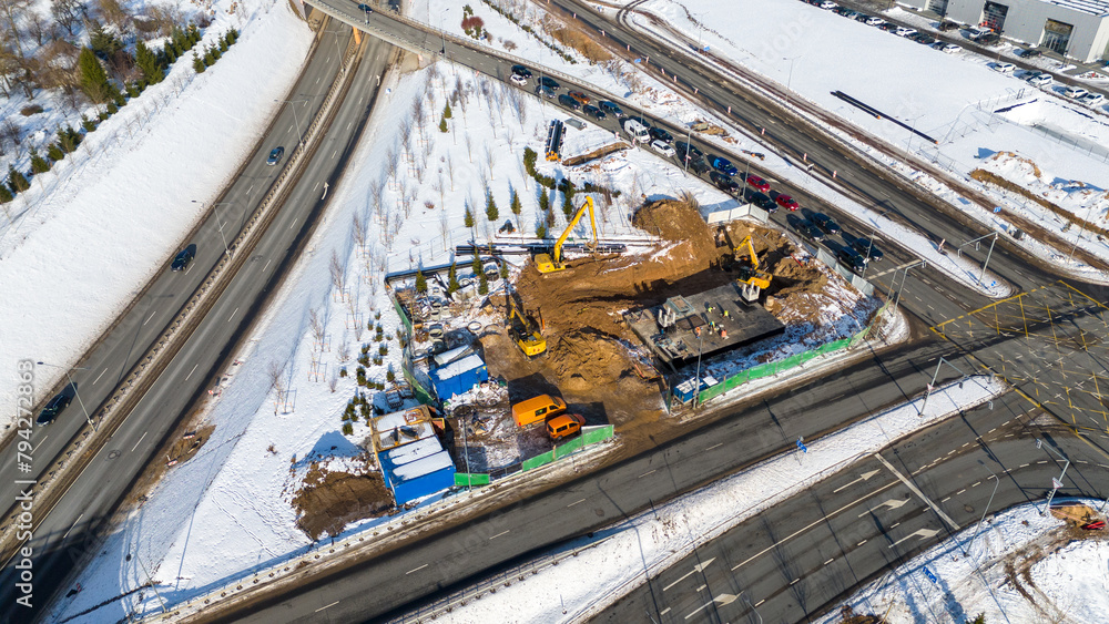 Drone photography of laying new sewage pipes near a road during winter day