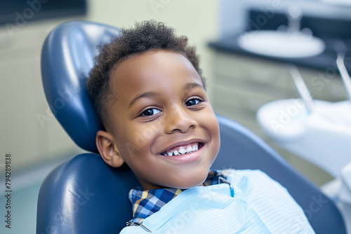 A young boy smiling while sitting on the dentist's chair