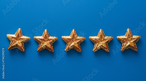 Five golden glitter stars on blue background