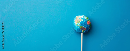Earth globe lollipop on a blue background