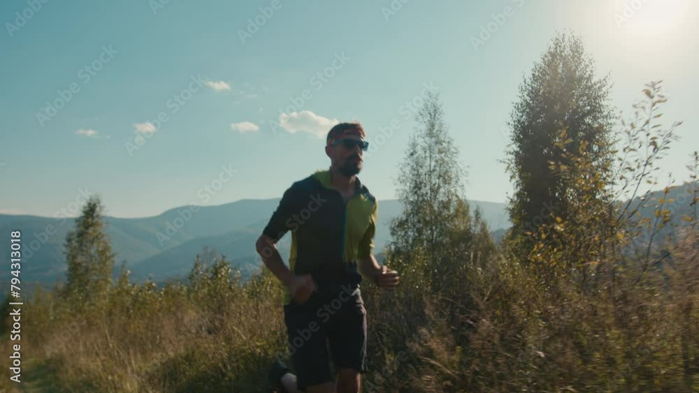 Athletic Caucasian man male guy sportswear sunglasses runner hiker running valley hiking run moving climbing up mountain exercising green hill outdoors adventure sport healthy lifestyle active workout Athletic Caucasian man male guy sportswear sunglasses runner hiker running valley hiking run moving climbing up mountain exercising green hill outdoors adventure sport healthy lifestyle active workout
