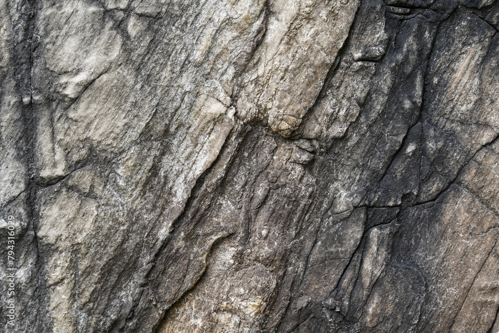 Empty light brown and grey stone wall on cave surface for abstract background and texture. Template for design, natural patterns, space for work, banner,seamless wallpaper, close up. Empty light brown and grey stone wall on cave surface for abstract background and texture. Template for design, natural patterns, space for work, banner,seamless wallpaper, close up.