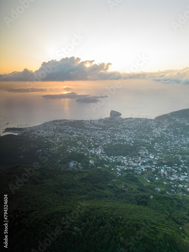 Aerial view at dawn from Mount Epomeo in Ischia. Flight in the clouds with a sea view photo