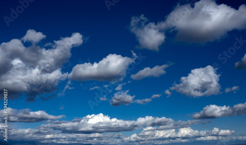 Slika na platnu Fleecy clouds against blue sky.