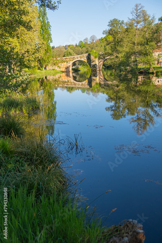 Medieval stone bridge over the Arnoia river in the beautiful village of Allariz, Galicia. Spain photo