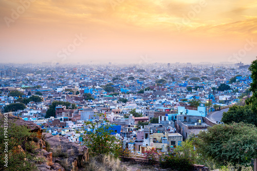 aerial drone shot at dusk sunset showing jodhpur blue city cityscape showing traditional houses in middle of aravalli with colorful densely packed houses photo