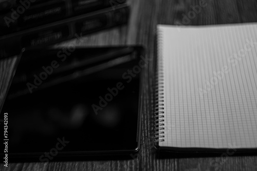 Workplace. Notebook with black marker and coffee mug on wooden table