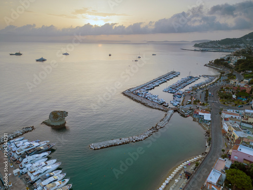 Vista aerea dell'alba del porto di Lacco Ameno ad Ischia. Roccia, mare, sole e mille colori photo